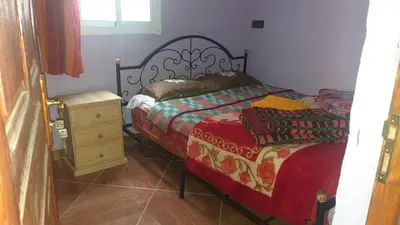 a bedroom with two twin beds and a dresser at Merzouga Quiet apart &camels trecking in Merzouga