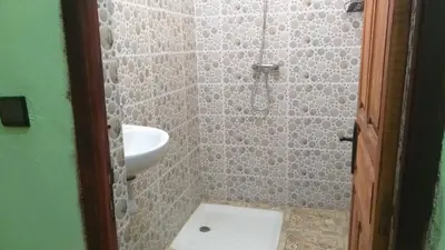 a bathroom with a sink and a shower with a toilet at Merzouga Quiet apart &camels trecking in Merzouga