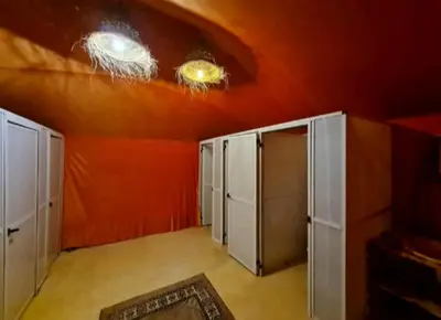 a room with two doors and a red ceiling at Bedouin Desert Camp in Merzouga