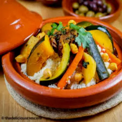 a bowl of food with vegetables on a table at Bedouin Desert Camp in Merzouga