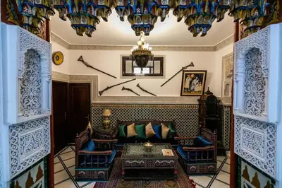 a living room with a couch and a chandelier at Spacious Apartment in Fès with Private Pool, 150 sqm in Fès