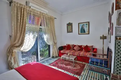 a living room with a red couch and a window at Spacious Apartment in Fès with Private Pool, 150 sqm in Fès