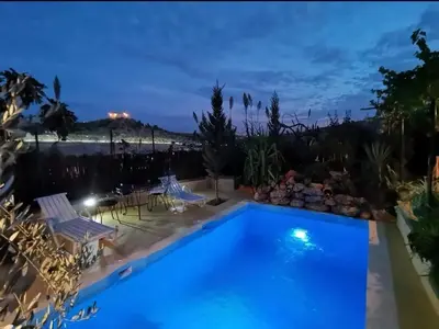 a pool with a view at night at Cosy Apartment in Fes El Bali, 25 m², Private Garden in Fès