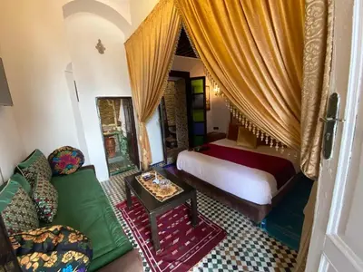 a bedroom with a bed and a couch and a table at Charming Apartment in Fès - 30 m² + View in Fès