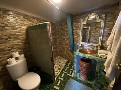 a bathroom with a white toilet and a sink at Charming Apartment in Fès - 30 m² + View in Fès