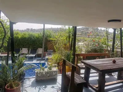 a patio with a table and chairs and a pool at Charming Apartment in Fès - 30 m² + View in Fès