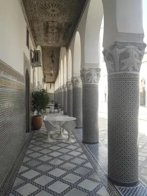 a bathroom with a white tub in a building with columns at Charming Apartment in Fès - 30 m² + View in Fès