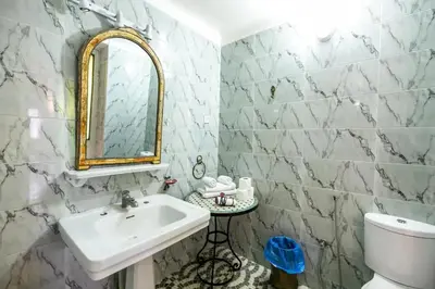 a bathroom with a sink and a mirror at Charming Apartment in Fes El Bali, 150m² with Garden in Fès
