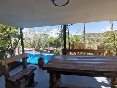 a view from the porch of a house with a table and benches at Charming Apartment in Fes El Bali, 150m² with Garden in Fès
