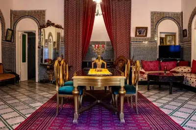 a living room with a table and chairs at Charming Apartment in Fes El Bali, 150m² with Garden in Fès