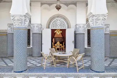 a patio with a table and chairs in a building at Charming Apartment in Fes El Bali, 150m² with Garden in Fès