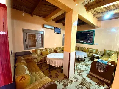 a living room with couches and a table in a room at Scenic Lakeview House Near 5-Star Widian Hotel in Bine el Ouidane