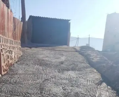 a dirt road with a blue door on the side of a building at Scenic Lakeview House Near 5-Star Widian Hotel in Bine el Ouidane