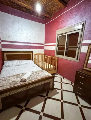 a bedroom with a bed and a window at Scenic Lakeview House Near 5-Star Widian Hotel in Bine el Ouidane