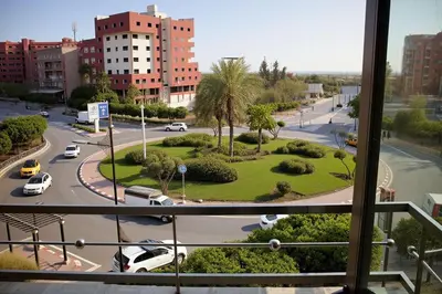 a view from a window of a city street with cars at Hotel Golden Flora in Beni Mellal