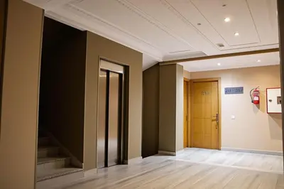 an empty hallway with stairs in a building at Hotel Golden Flora in Beni Mellal