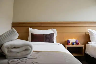 a hotel room with a bed with towels on it at Hotel Golden Flora in Beni Mellal