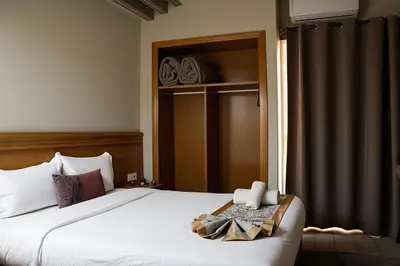 a bedroom with a large white bed with a window at Hotel Golden Flora in Beni Mellal