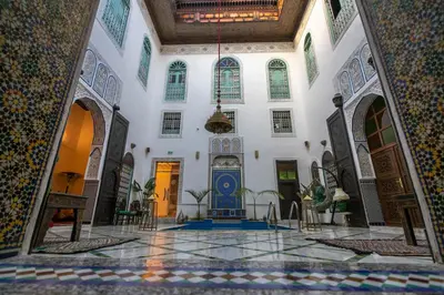 a lobby of a mosque with a blue door at Palais Riad Chahd Luxury in Fès