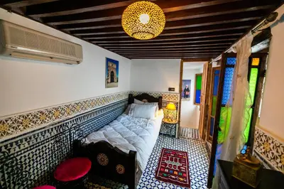 a bedroom with a bed in the corner of a room at Palais Riad Chahd Luxury in Fès