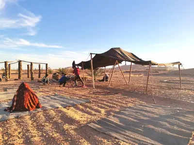 a group of tents in the desert at Jardin Kotori Luxury Camp in Merzouga