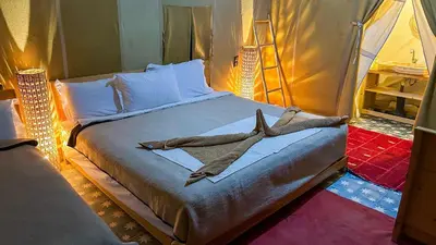 a bedroom with a bed with two bones on it at Jardin Kotori Luxury Camp in Merzouga