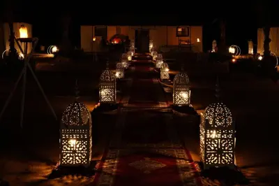 a row of lights on the ground at night at Merzouga Desert Luxury Camp in Merzouga