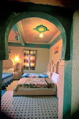 a bedroom with a large bed in a room at Dar Tafouyte in Merzouga