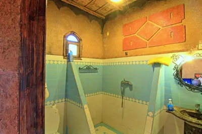 a bathroom with a shower and a toilet and a sink at Dar Tafouyte in Merzouga