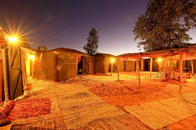 a group of tents with lights in front of them at Dar Tafouyte in Merzouga