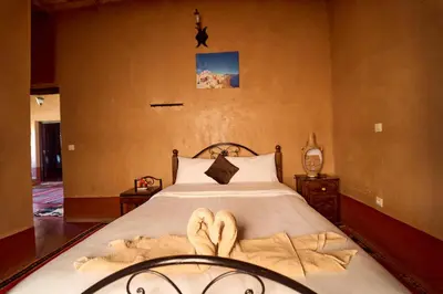 a bedroom with a bed with towels on it at Chez Brahim vue panoramique in Aït Ben Haddou