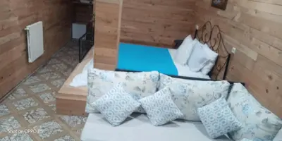 a room with a couch with pillows on it at Tamanoucht in Ifrane