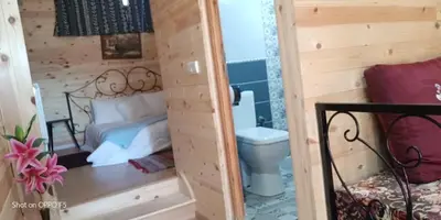 a small room with a bed and a toilet at Tamanoucht in Ifrane