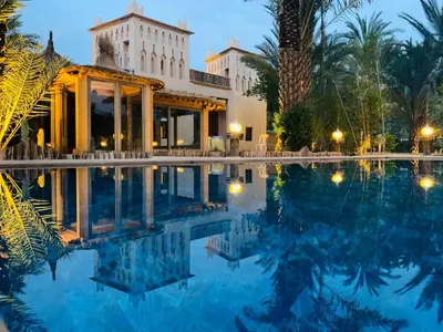 a resort with a swimming pool at night at Dar Hnini in Zagora