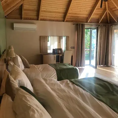 a living room with two beds and a kitchen at Dar Hnini in Zagora