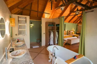 a bathroom with two sinks and a bath tub at Dar Hnini in Zagora
