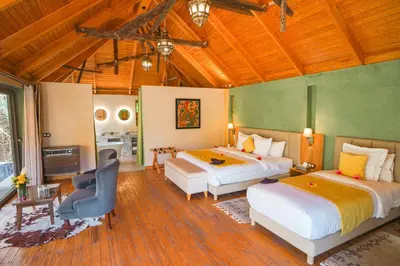 a hotel room with two beds and a kitchen at Dar Hnini in Zagora