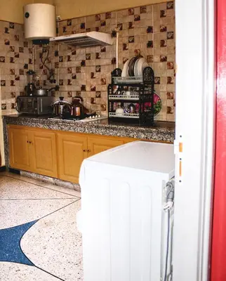 a kitchen with a white refrigerator in a room at Hostel Afgo Rooftop in Ouarzazate