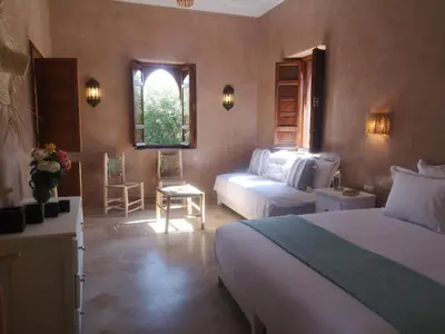 a hotel room with two beds and a window at Domaine Casa Cecilia in Marrakech