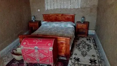 a bedroom with a bed with two night stands and two tables at Spacious House in Hassilabied in Hassilabied