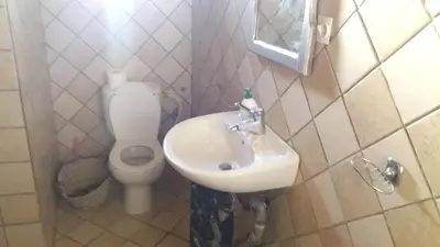 a bathroom with a sink and a toilet at Spacious House in Hassilabied in Hassilabied