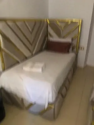 a bedroom with a bed with a book on it at Riad Malak in Meknès