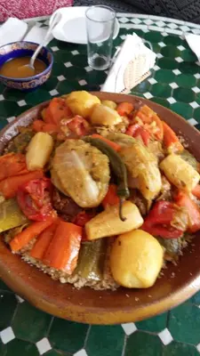 a plate of food with vegetables on a table at Riad Malak in Meknès