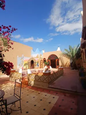 a building with a chair in front of it at Dar M'hamid in Mhamid