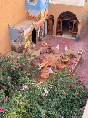 an aerial view of a courtyard with tables and flowers at Dar M'hamid in Mhamid