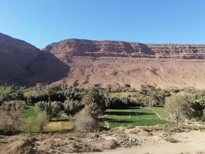 a view of the desert with mountains in the background at Chambres dans casbah - Gite D'étape Gorges De Ziz in Er Rachidia