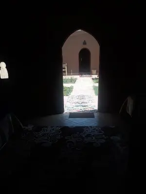 a dark room with a hallway with an archway at Mhamid Auberge Saharaespace in Mhamid