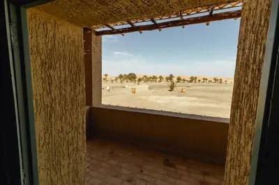a window in a room with a view of the desert at Dar El Janoub in Merzouga