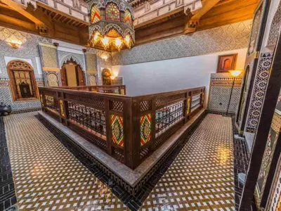 a room with a chandelier and a staircase in a building at Charming Riad Ouliya in Fs in Fès