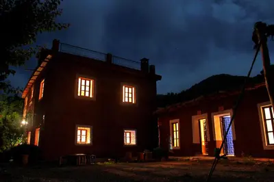 a house with its lights on at night at Gîte Imarin in Agouti